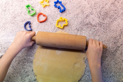 High angle view of baby hand on cutting board