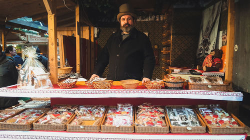 Portrait of man standing at market stall