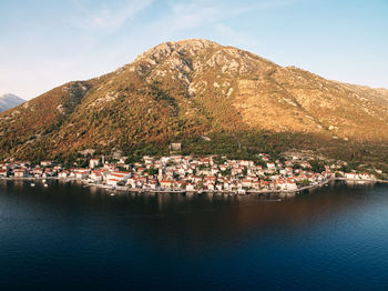 Scenic view of sea and mountains against clear sky