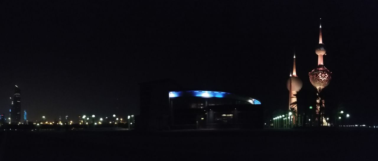 ILLUMINATED MODERN BUILDINGS IN CITY AT NIGHT