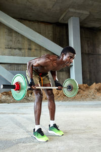 Portrait of young woman exercising in gym