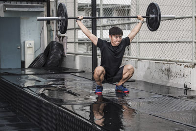 Man training at rooftop gym in bangkok