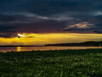 Scenic view of field against sky during sunset