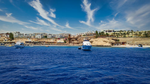Sharm el sheikh egypt , marina daylight  view  with yachts in water, hotels  and clouds in the sky