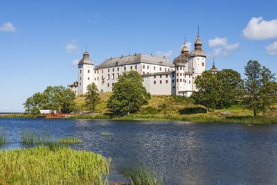 Beautiful läckö castle on a hill by a lake