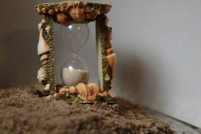 Close-up of clock on glass table