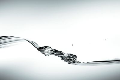 Close-up of water over white background