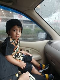 Portrait of smiling girl sitting in car