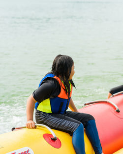 Rear view of women on boat in sea