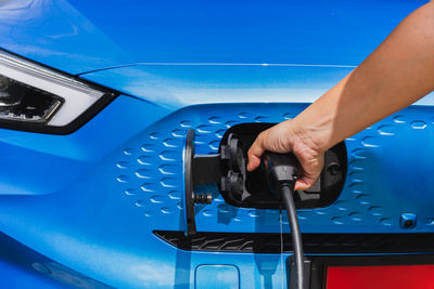 Cropped hand of man repairing car