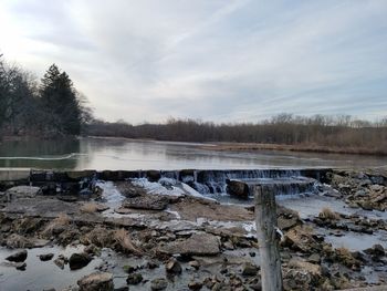 Scenic view of lake against sky during winter