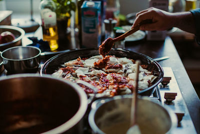 Cropped image of hand preparing food