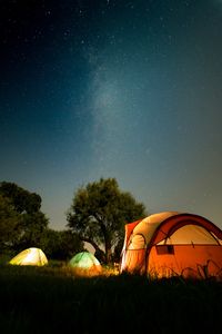 Tent on field against sky at night