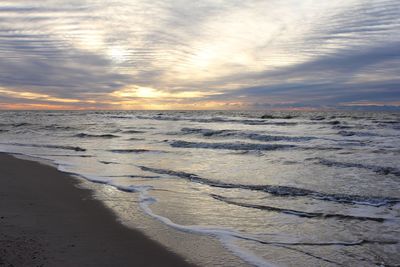 Scenic view of beach against sky during sunset