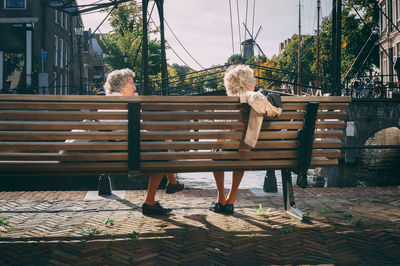Woman sitting on bench in park