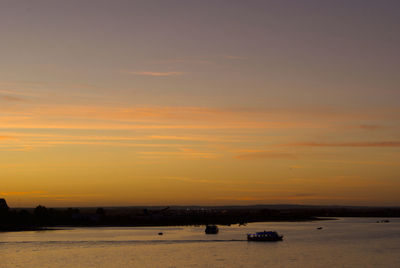 Scenic view of sea against romantic sky at sunset