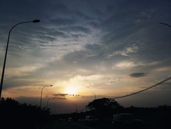 Cars on road at sunset