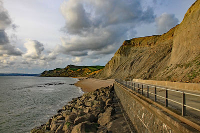 Scenic view of sea and mountains against sky