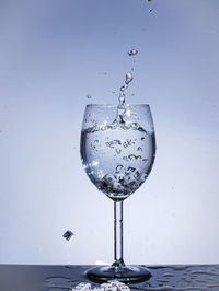 Close-up of glass of water against white background
