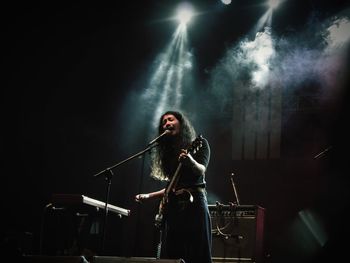 Young woman playing at music concert