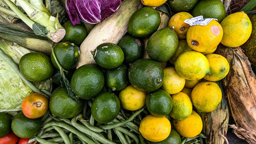 Photo of piles of lemons and vegetables taken during the day from a high angle