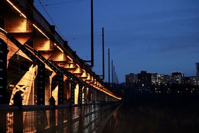 Illuminated bridge against sky at night