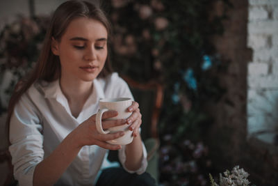 Young woman drinking coffee