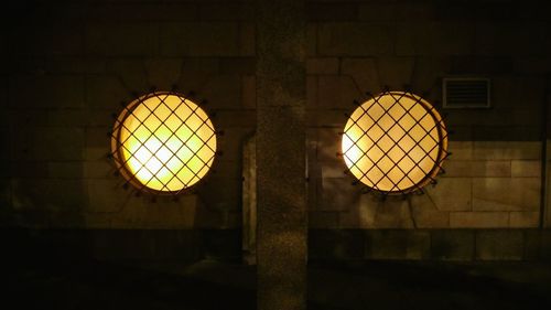 Low angle view of illuminated pendant lights hanging from ceiling