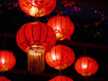 Low angle view of illuminated lanterns hanging at night