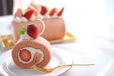 Close-up of cake with strawberry served on table