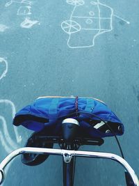 Cropped image of bicycle with luggage on road