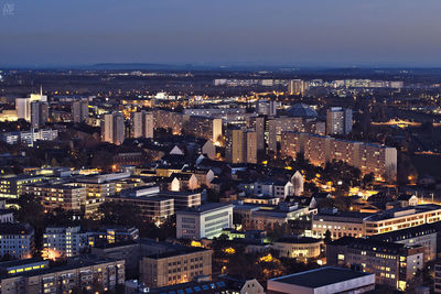Aerial view of city lit up at night
