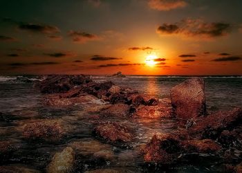 View of sea against cloudy sky during sunset