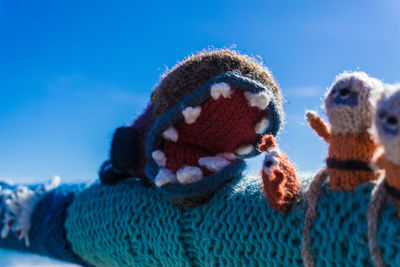 Close-up of sheep against blue sky