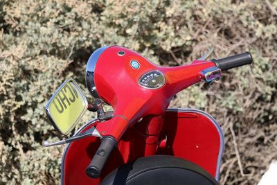 High angle view of red motor scooter against plant