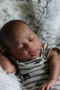 High angle view of baby boy lying on bed