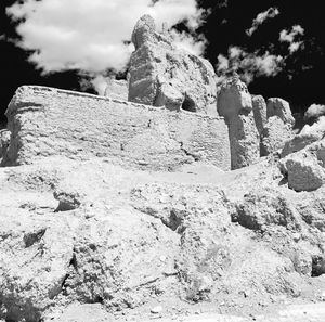 Low angle view of rock formation against sky