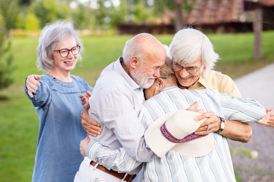 Portrait of smiling friends holding hands