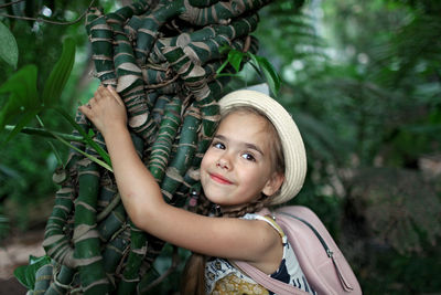 Portrait of smiling boy against plants