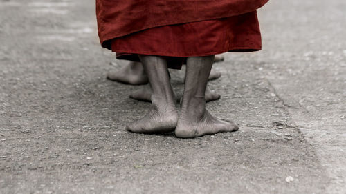 Low section of monks walking on street