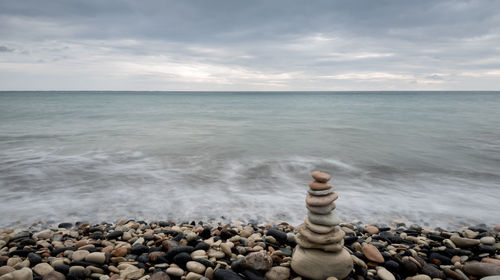 Pyramid of balancing pebbles, in the ocean
