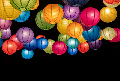 Low angle view of illuminated lanterns hanging on ceiling