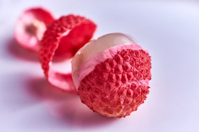 Close-up of pink fruit against white background