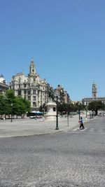 Buildings against clear blue sky