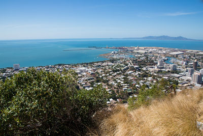 High angle view of townscape by sea against sky