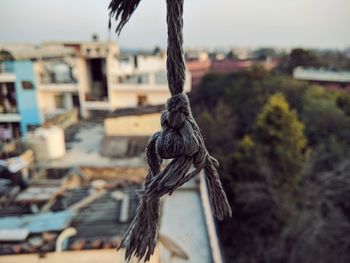 Close-up of rope tied up against sky