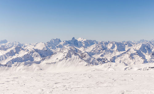 Scenic view of snowcapped mountains against clear sky