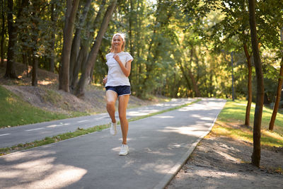 Full length of woman running on road