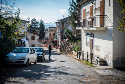 Street amidst houses and buildings in city