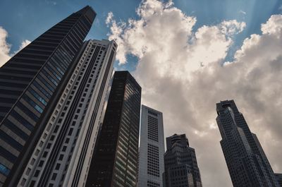 Low angle view of modern building against cloudy sky